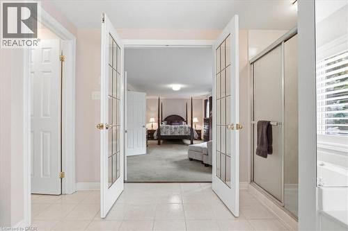 Full bathroom with a shower stall, french doors, a bath, and ensuite bathroom - 54 Woodcrest Court, Kitchener, ON - Indoor Photo Showing Other Room