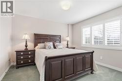 Bedroom with baseboards and light carpet - 