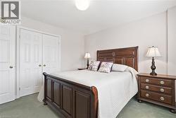 Carpeted bedroom featuring a closet - 