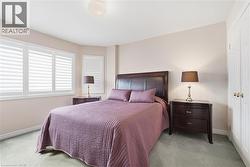 Bedroom featuring light colored carpet and a closet - 