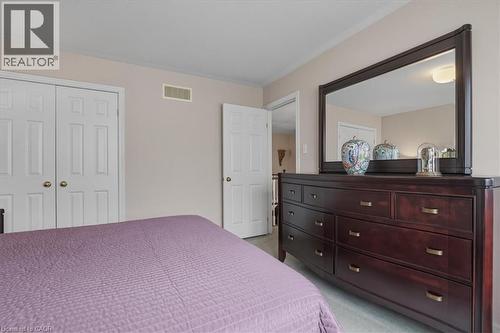 Bedroom with light colored carpet, a closet, and crown molding - 54 Woodcrest Court, Kitchener, ON - Indoor Photo Showing Bedroom