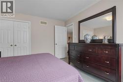 Bedroom with light colored carpet, a closet, and crown molding - 