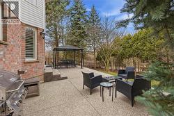 Fenced backyard featuring a gazebo, a patio, grilling area, and an outdoor living / dining area - 