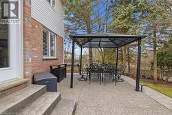 View of patio with outdoor dining area and a gazebo - 