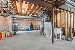 Unfinished below grade area featuring water heater and heating unit - 