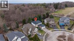 Aerial view of residential area featuring a heavily wooded area - 