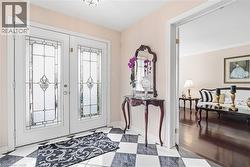 Foyer featuring french doors and baseboards - 