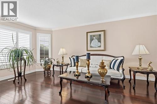Living room featuring dark wood-type flooring and ornamental molding - 54 Woodcrest Court, Kitchener, ON - Indoor