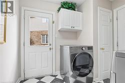 Laundry area with light floors and cabinet space - 