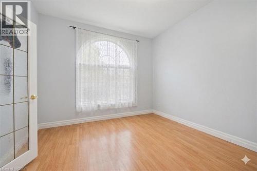 Unfurnished room with light wood-style flooring and lofted ceiling.Virtually Decluttered – Furniture removed to show room dimensions. - 122 Grand River Boulevard, Kitchener, ON - Indoor Photo Showing Other Room