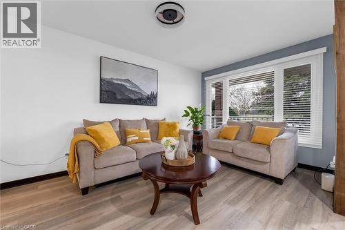Living room featuring baseboards and light wood-type flooring - 51 Independence Drive, Hamilton, ON - Indoor Photo Showing Living Room