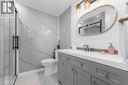 Full bathroom featuring a marble finish shower, vanity, stone wall, and light marble finish floors - 51 Independence Drive, Hamilton, ON - Indoor Photo Showing Bathroom