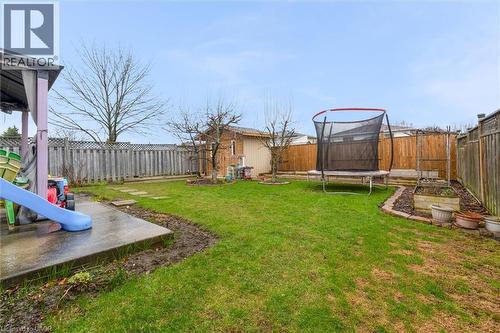 Fenced backyard with a trampoline and a patio area - 51 Independence Drive, Hamilton, ON - Outdoor With Backyard