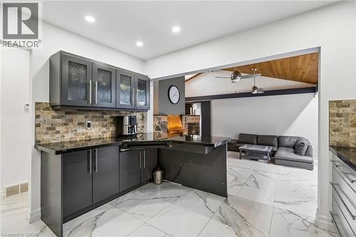 Kitchen with glass fronted cabinets, open floor plan, a ceiling fan, a peninsula, and vaulted ceiling - 3 Chicopee Terrace, Kitchener, ON - Indoor Photo Showing Kitchen