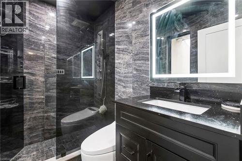 Full bathroom with tile walls, vanity, and a marble finish shower - 3 Chicopee Terrace, Kitchener, ON - Indoor Photo Showing Bathroom