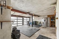Garage with stainless steel refrigerator with ice dispenser - 