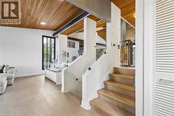 Staircase featuring wood finished floors and wood ceiling - 