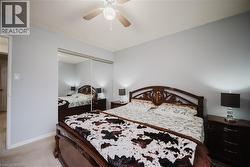 Bedroom with light colored carpet, ceiling fan, and a closet - 