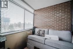 Living area with brick wall and a textured ceiling - 