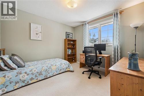 Bedroom with a desk, light colored carpet, and a textured ceiling - 488 Heather Hill Place, Waterloo, ON - Indoor Photo Showing Bedroom