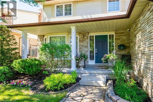 Property entrance featuring stone siding and covered porch - 488 Heather Hill Place, Waterloo, ON - Outdoor With Deck Patio Veranda