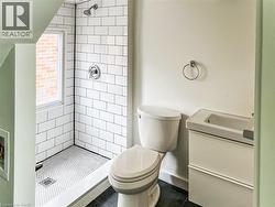 Bathroom featuring vanity, a stall shower, and dark tile patterned flooring - 