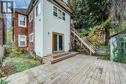 Wooden terrace featuring fire escape stairs to second and third floor - 