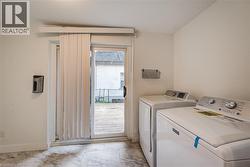 Laundry area featuring separate washer and dryer and patio door to backyard - 