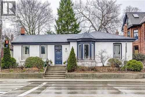 View of front of home featuring a chimney, brick siding, and roof with shingles - 315 Aberdeen Avenue, Hamilton, ON - Outdoor