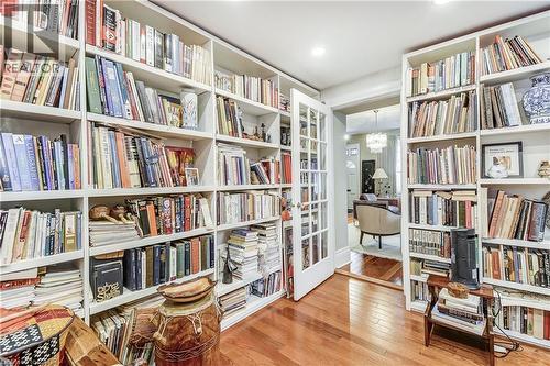 Sitting room featuring light wood-style floors and wall of books - 315 Aberdeen Avenue, Hamilton, ON - Indoor