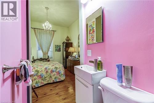Bedroom featuring hardwood / wood-style flooring and a chandelier - 315 Aberdeen Avenue, Hamilton, ON - Indoor Photo Showing Laundry Room