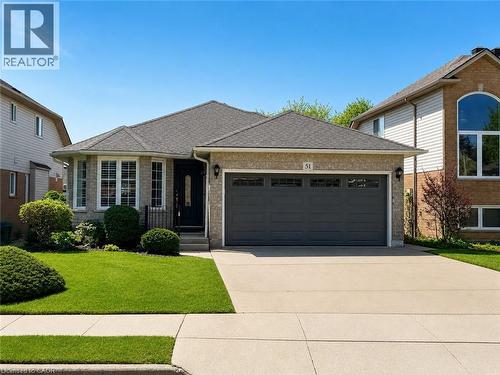 Brick facade residence featuring a two-car garage, a concrete driveway, and a shingle roof - 51 Redtail Crescent, Hamilton, ON - Outdoor With Facade