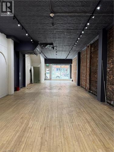 Retail Space with rail lighting and brick wall - 228 James Street N, Hamilton, ON 