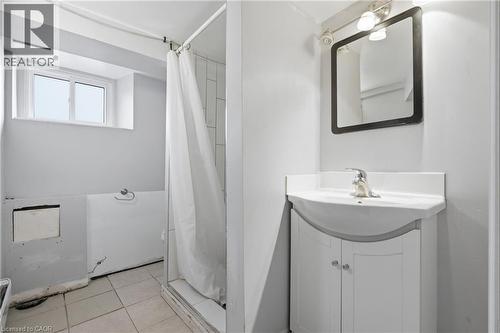 Bathroom featuring vanity, a stall shower, and light tile patterned floors - 30 Regina Street N, Waterloo, ON 