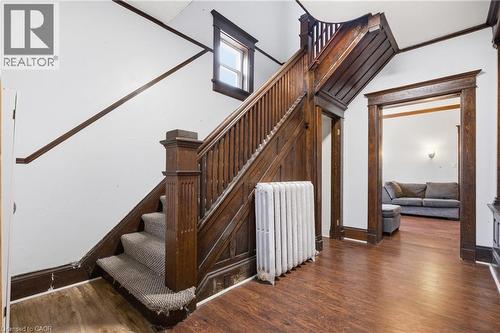 Staircase with wood finished floors and radiator heating unit - 30 Regina Street N, Waterloo, ON 