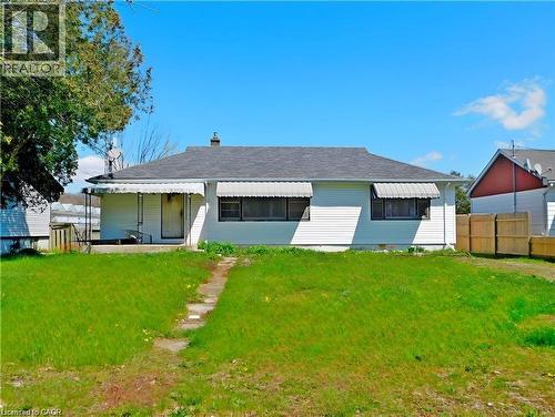 Rear view of house with a chimney, a porch, and roof with shingles - 2474 Highway 24, Simcoe, ON 