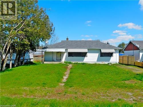 Rear view of house with a chimney and covered porch - 2474 Highway 24, Simcoe, ON 