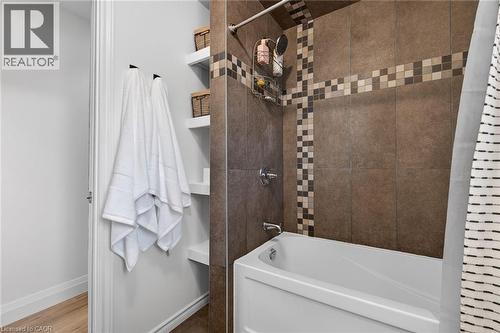 Full bathroom with shower / bath combination with curtain and wood finished floors - 844 Upper Wellington Street, Hamilton, ON - Indoor Photo Showing Bathroom