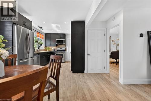 Kitchen featuring stainless steel appliances, light wood-style floors, tasteful backsplash, recessed lighting, and modern cabinets - 844 Upper Wellington Street, Hamilton, ON - Indoor