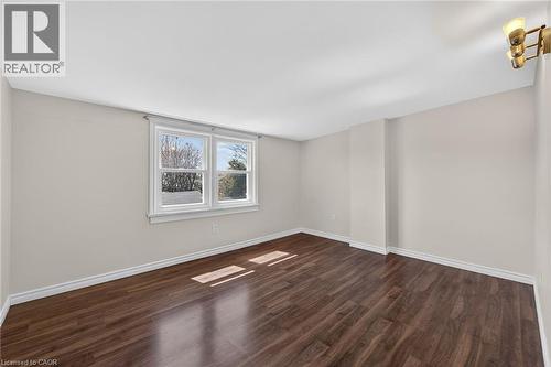 Unfurnished room featuring dark wood finished floors and baseboards - 844 Upper Wellington Street, Hamilton, ON - Indoor Photo Showing Other Room
