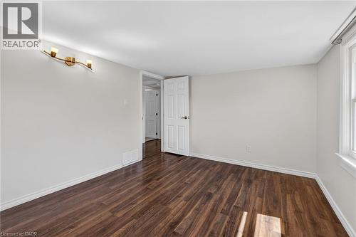 Spare room featuring dark wood-style flooring and baseboards - 844 Upper Wellington Street, Hamilton, ON - Indoor Photo Showing Other Room