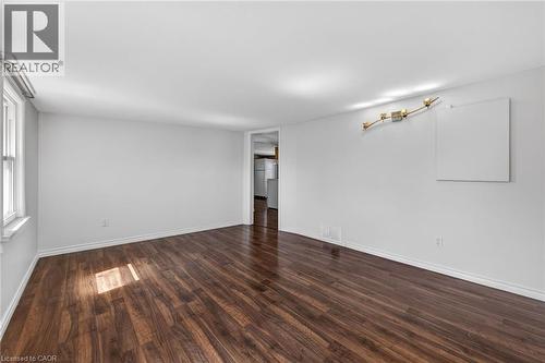 Empty room with dark wood-style flooring and baseboards - 844 Upper Wellington Street, Hamilton, ON - Indoor Photo Showing Other Room