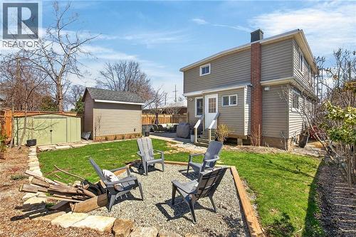 Rear view of property with a patio area, a fire pit, a shed, a chimney, and entry steps - 844 Upper Wellington Street, Hamilton, ON - Outdoor