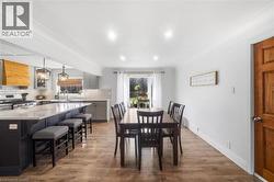 Dining room featuring light wood finished floors, plenty of natural light, and crown molding - 