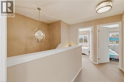 Hallway with light carpet, a chandelier, and an upstairs landing - 750 Lawrence Street Unit# 88, Cambridge, ON - Indoor Photo Showing Other Room