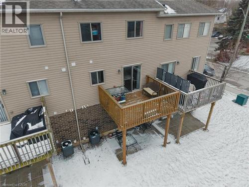 Rear view of property featuring roof with shingles and a wooden deck - 750 Lawrence Street Unit# 88, Cambridge, ON - Outdoor With Exterior