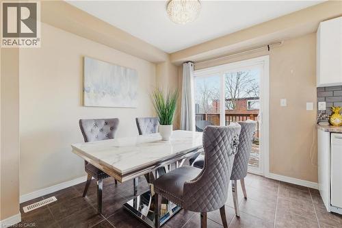 Dining area with baseboards and tile patterned floors - 750 Lawrence Street Unit# 88, Cambridge, ON - Indoor Photo Showing Dining Room