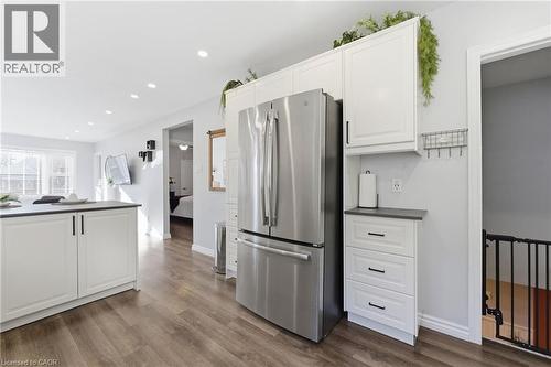 Kitchen featuring dark countertops, freestanding refrigerator, white cabinets, dark wood-style flooring, and recessed lighting - 171 Glencairn Avenue, Hamilton, ON - Indoor Photo Showing Kitchen