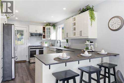 Kitchen with a kitchen bar, a peninsula, open shelves, stainless steel appliances, and recessed lighting - 171 Glencairn Avenue, Hamilton, ON - Indoor