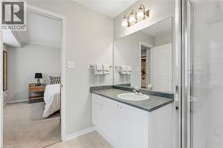 Full bath featuring ensuite bathroom, vanity, light colored carpet, and a shower stall - 